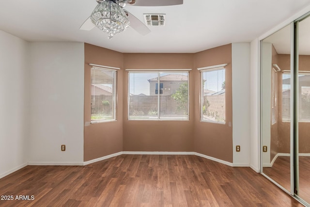 12425 W Willow Ave, El Mirage, AZ 85335 - empty room featuring a ceiling fan, wood finished floors, and baseboards
