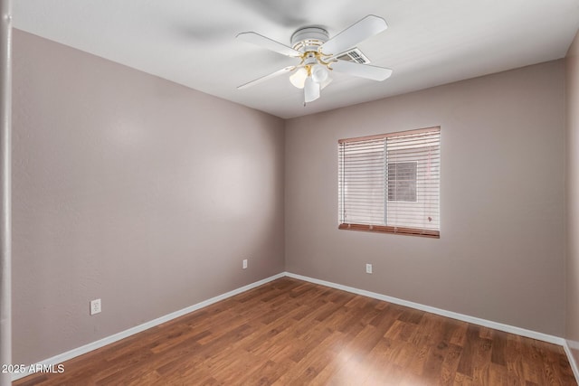 12425 W Willow Ave, El Mirage, AZ 85335 - spare room featuring baseboards, ceiling fan, and wood finished floors
