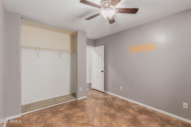 12425 W Willow Ave, El Mirage, AZ 85335 - unfurnished bedroom featuring a closet, baseboards, and a ceiling fan