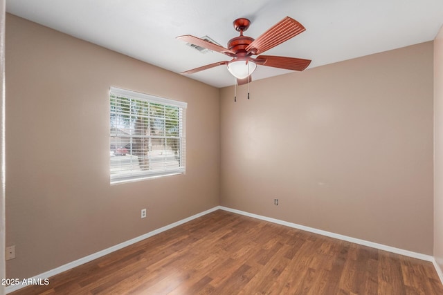12425 W Willow Ave, El Mirage, AZ 85335 - empty room with baseboards, wood finished floors, and ceiling fan