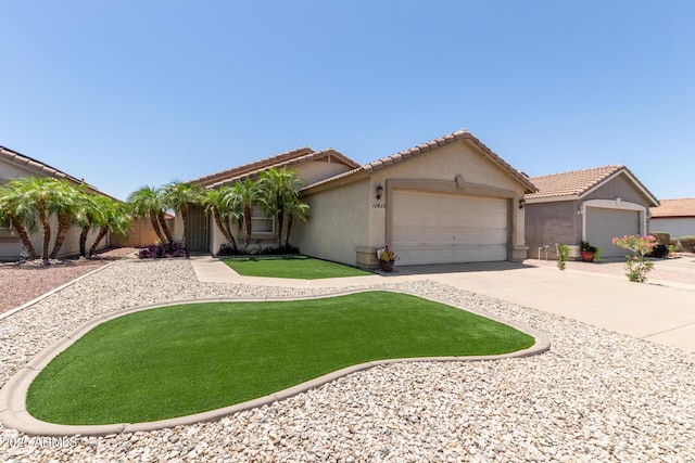 12425 W Willow Ave, El Mirage, AZ 85335 - view of front of property with an attached garage, stucco siding, driveway, a front lawn, and a tile roof