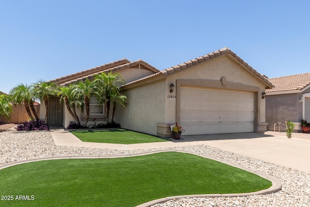 12425 W Willow Ave, El Mirage, AZ 85335 - view of front facade featuring an attached garage, concrete driveway, stucco siding, and a front lawn