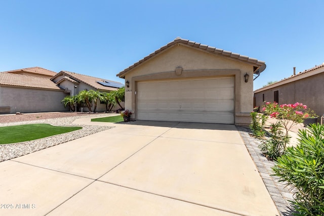 12425 W Willow Ave, El Mirage, AZ 85335 - view of front of house with a garage, stucco siding, and concrete driveway