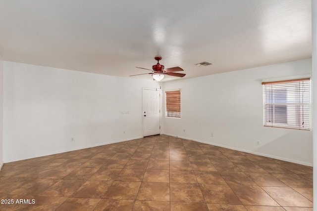12425 W Willow Ave, El Mirage, AZ 85335 - tiled empty room featuring ceiling fan