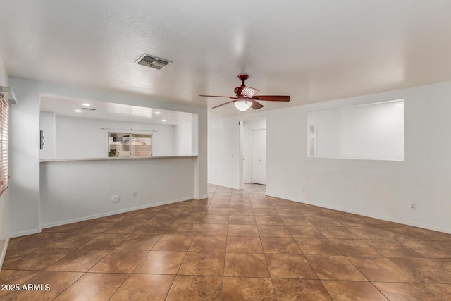 12425 W Willow Ave, El Mirage, AZ 85335 - unfurnished living room with ceiling fan and baseboards
