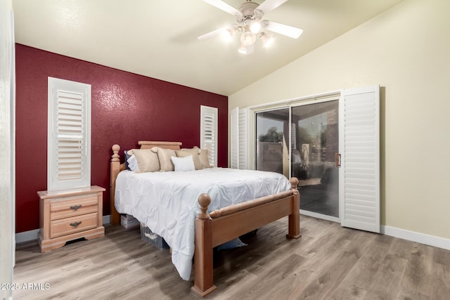 bedroom featuring ceiling fan, lofted ceiling, light wood-type flooring, and access to exterior
