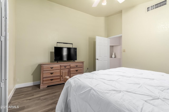 bedroom featuring ceiling fan, baseboards, visible vents, and wood finished floors