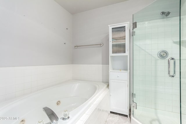 full bath featuring tile patterned flooring, a shower stall, and a tub with jets