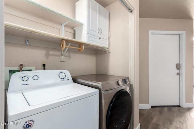 laundry room with baseboards, cabinet space, independent washer and dryer, and wood finished floors