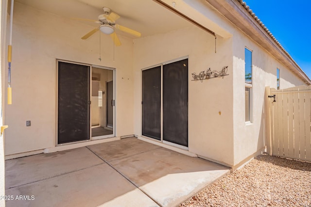 view of patio / terrace with ceiling fan and fence