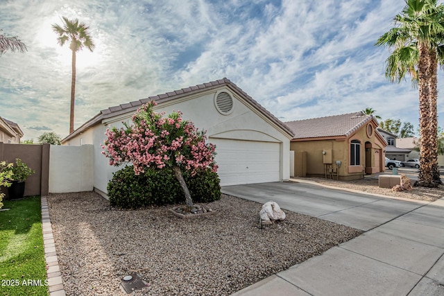 14624 N 90th Ln, Peoria, AZ 85381 - ranch-style home with driveway, stucco siding, a tiled roof, and an attached garage