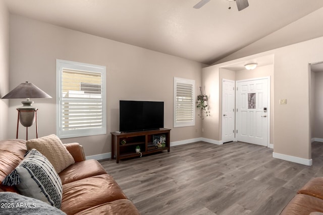 living room with baseboards, a ceiling fan, wood finished floors, and vaulted ceiling