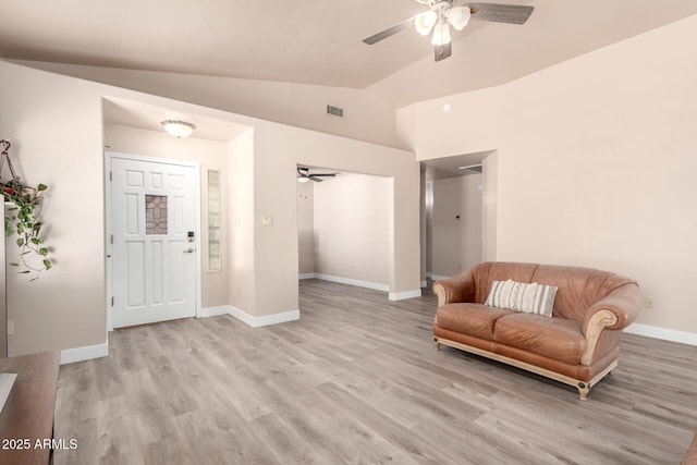 sitting room featuring baseboards, ceiling fan, light wood-type flooring, and lofted ceiling