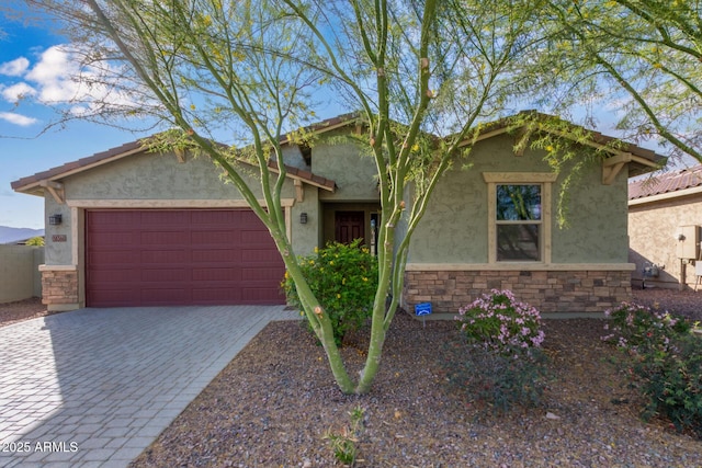 18360 W Alice Ave, Waddell, AZ 85355 - ranch-style house featuring stone siding, decorative driveway, stucco siding, and an attached garage