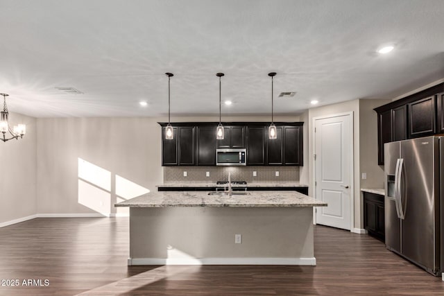 18360 W Alice Ave, Waddell, AZ 85355 - kitchen featuring decorative backsplash, visible vents, dark wood finished floors, appliances with stainless steel finishes, and an island with sink