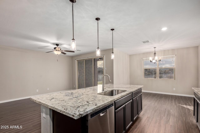 18360 W Alice Ave, Waddell, AZ 85355 - kitchen featuring dark wood-style flooring, ceiling fan with notable chandelier, baseboards, stainless steel dishwasher, and a sink
