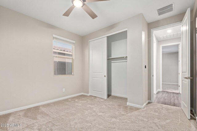 18360 W Alice Ave, Waddell, AZ 85355 - unfurnished bedroom featuring baseboards, carpet, a closet, and visible vents