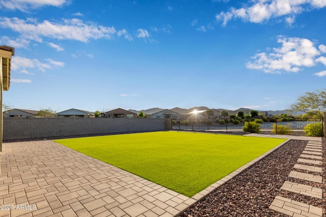 18360 W Alice Ave, Waddell, AZ 85355 - view of yard featuring a patio, a fenced backyard, and a residential view