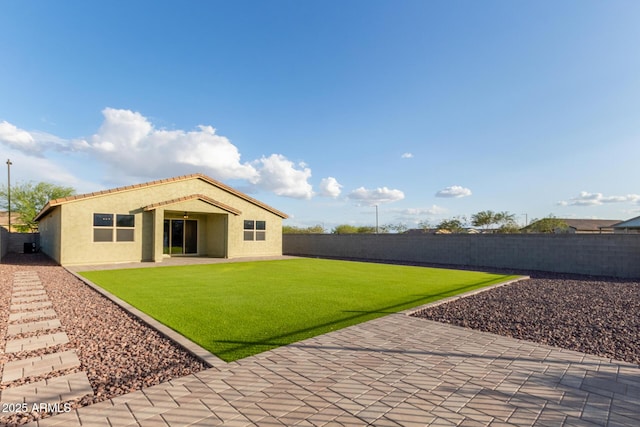 18360 W Alice Ave, Waddell, AZ 85355 - back of house with a patio, a fenced backyard, a lawn, and stucco siding