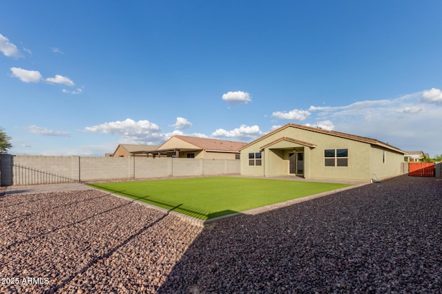 18360 W Alice Ave, Waddell, AZ 85355 - back of house with a patio, a fenced backyard, a lawn, and stucco siding