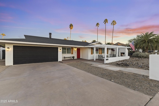 view of front facade with a garage and covered porch