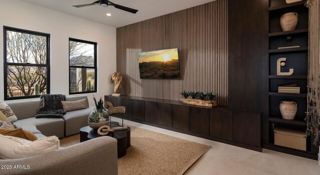 tiled living room with a ceiling fan, recessed lighting, and built in features