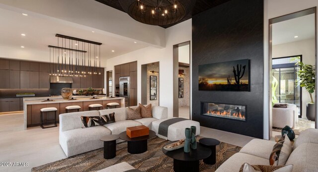 living area with recessed lighting, a chandelier, and a fireplace