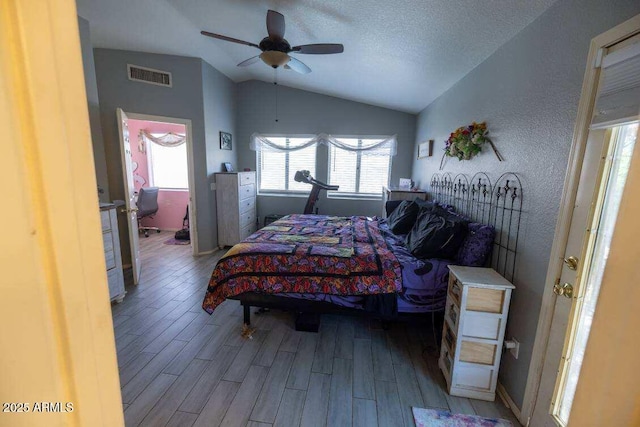 bedroom featuring lofted ceiling, wood finished floors, and ceiling fan
