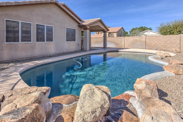 view of swimming pool with a fenced backyard