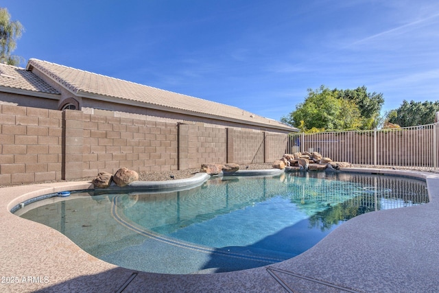 view of pool with a fenced backyard