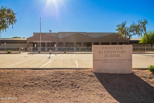 view of property with uncovered parking and fence