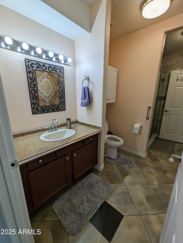 bathroom featuring tile patterned flooring, toilet, a shower with door, and vanity