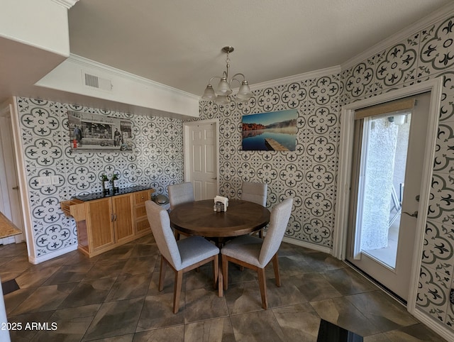 dining area featuring ornamental molding and a notable chandelier