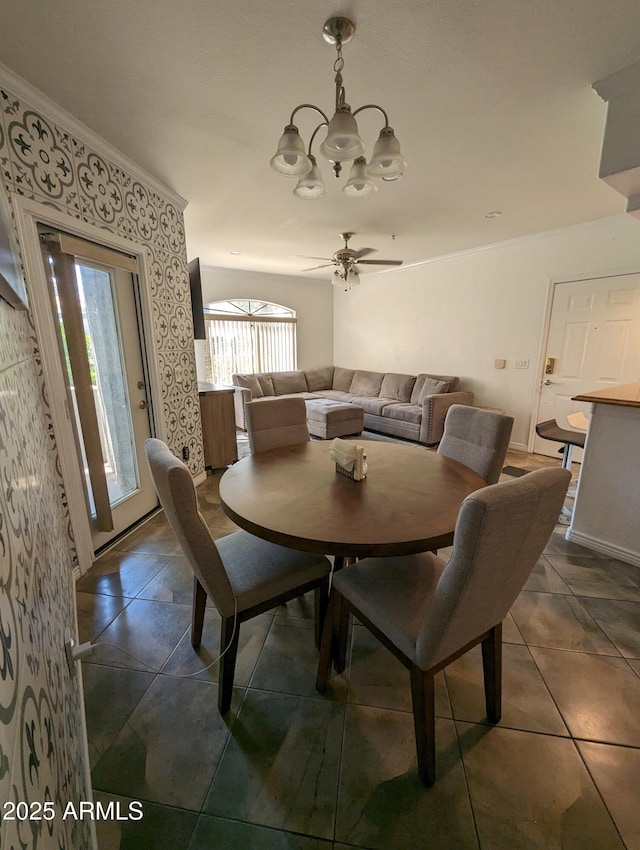 dining space featuring ceiling fan with notable chandelier