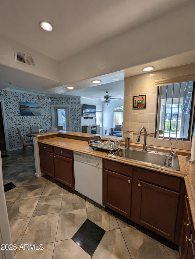 kitchen featuring ceiling fan, light tile patterned floors, dishwasher, and sink