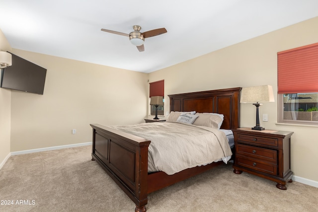 bedroom with ceiling fan and light colored carpet