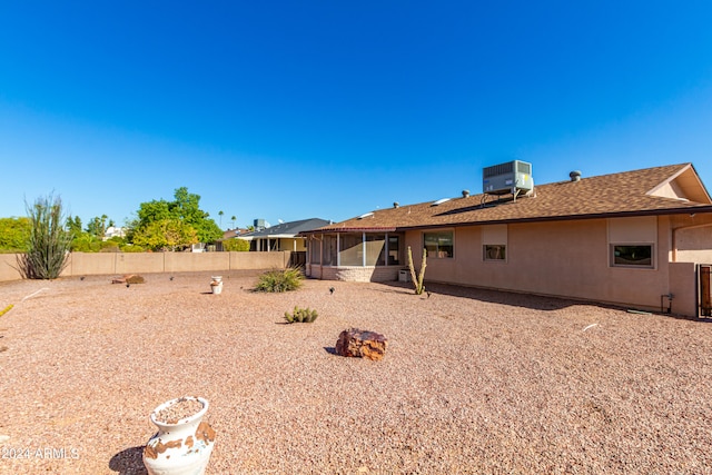 back of house featuring central air condition unit and a sunroom