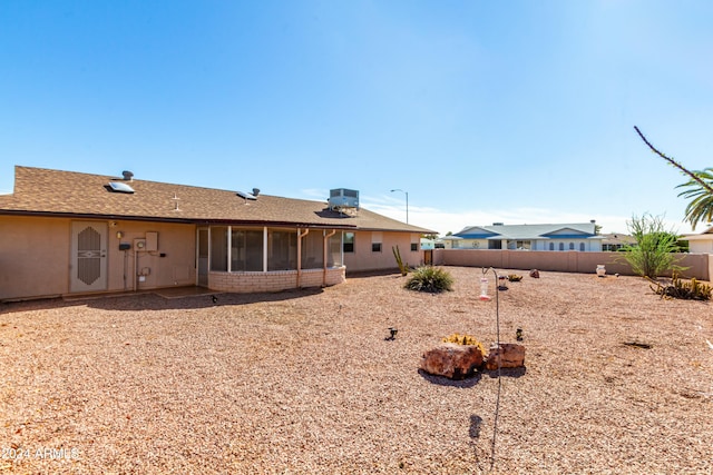 rear view of house featuring a sunroom