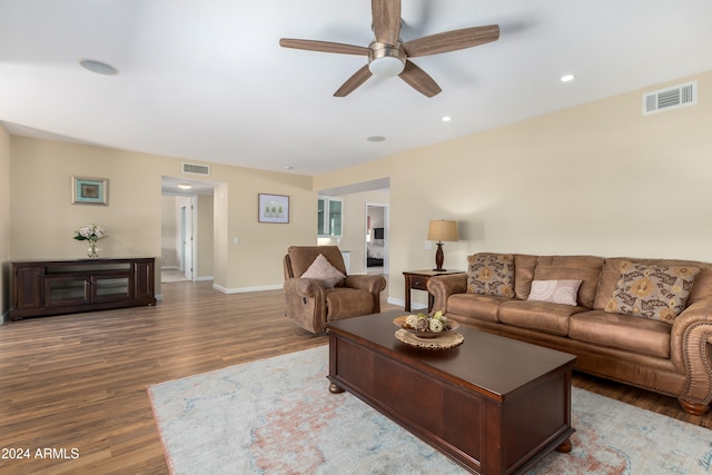 living room with wood-type flooring and ceiling fan