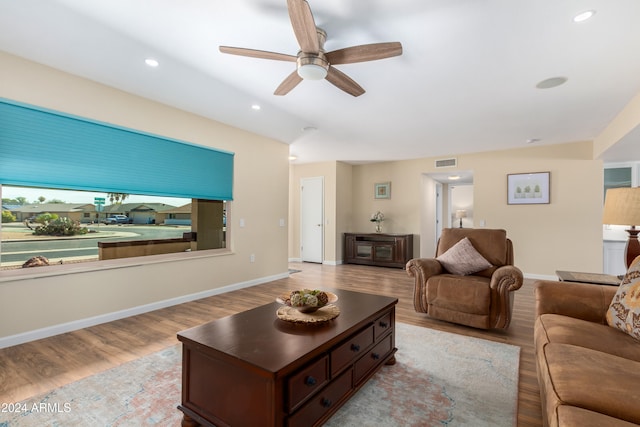 living room with light hardwood / wood-style floors and ceiling fan