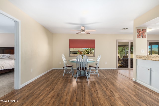 unfurnished dining area featuring dark hardwood / wood-style floors and ceiling fan