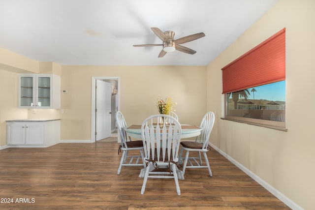 dining area with dark hardwood / wood-style flooring and ceiling fan