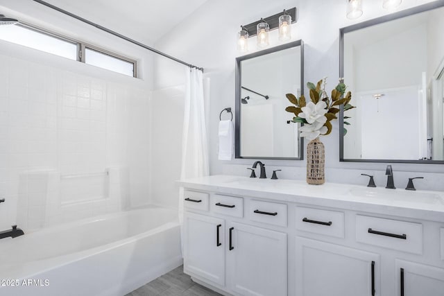 bathroom featuring double vanity, a sink, and shower / bath combo with shower curtain