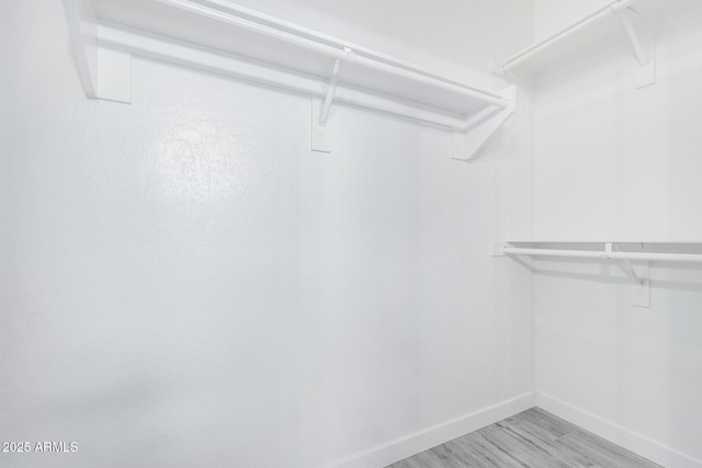 spacious closet with light wood finished floors