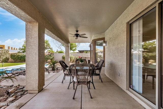 view of patio / terrace featuring ceiling fan, fence, and outdoor dining area