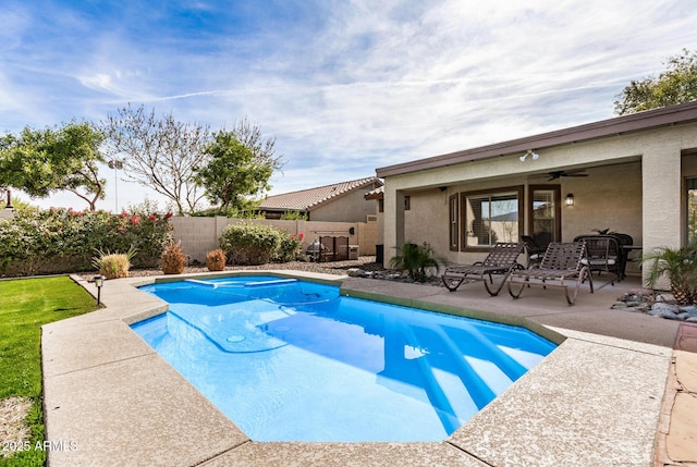 view of pool featuring ceiling fan, a patio area, a fenced backyard, and a fenced in pool