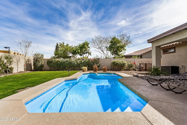 view of swimming pool with a lawn, a fenced backyard, and a fenced in pool