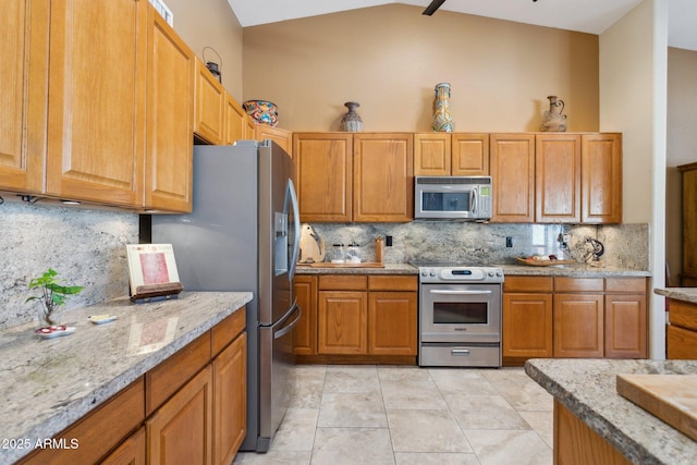 kitchen with backsplash, high vaulted ceiling, stainless steel appliances, and light stone counters