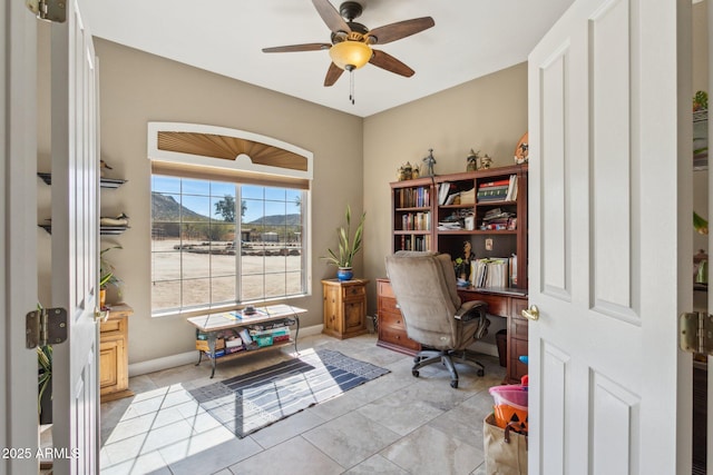 office area featuring ceiling fan, light tile patterned floors, and baseboards