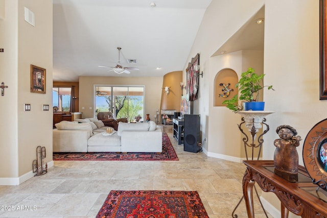 living room featuring a ceiling fan, visible vents, and baseboards